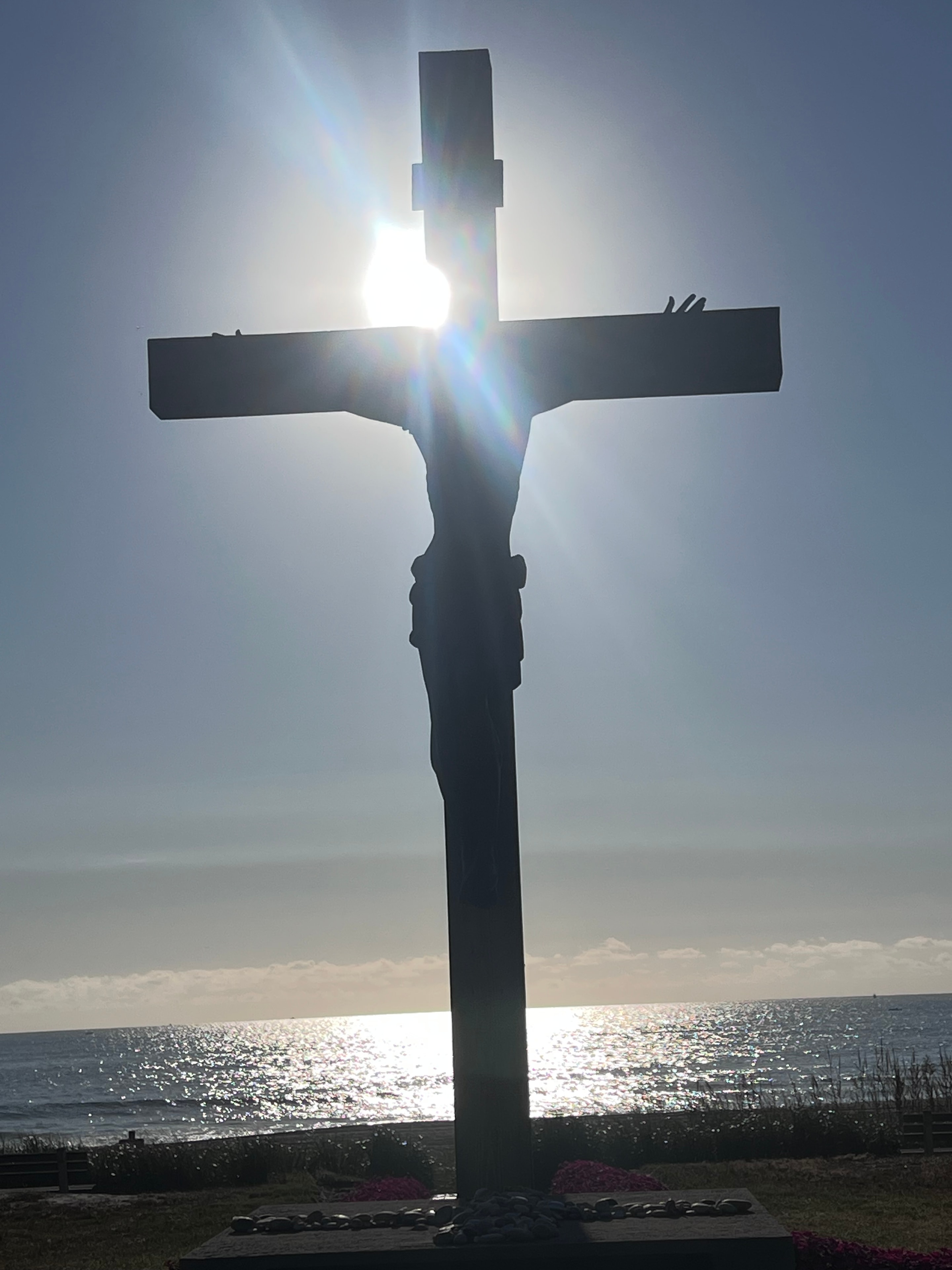 Cross silhouetted against the sky at a retreat